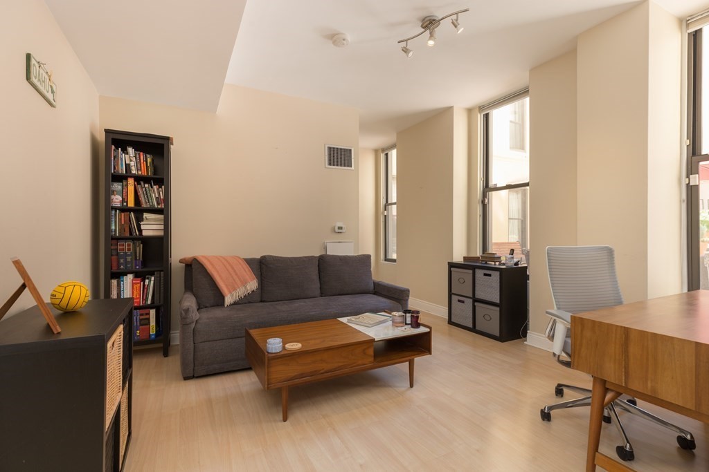 4 Charlesgate East, Unit 107 Boston, MA 02215 - Photo 6 of 12 a living room with furniture and a window