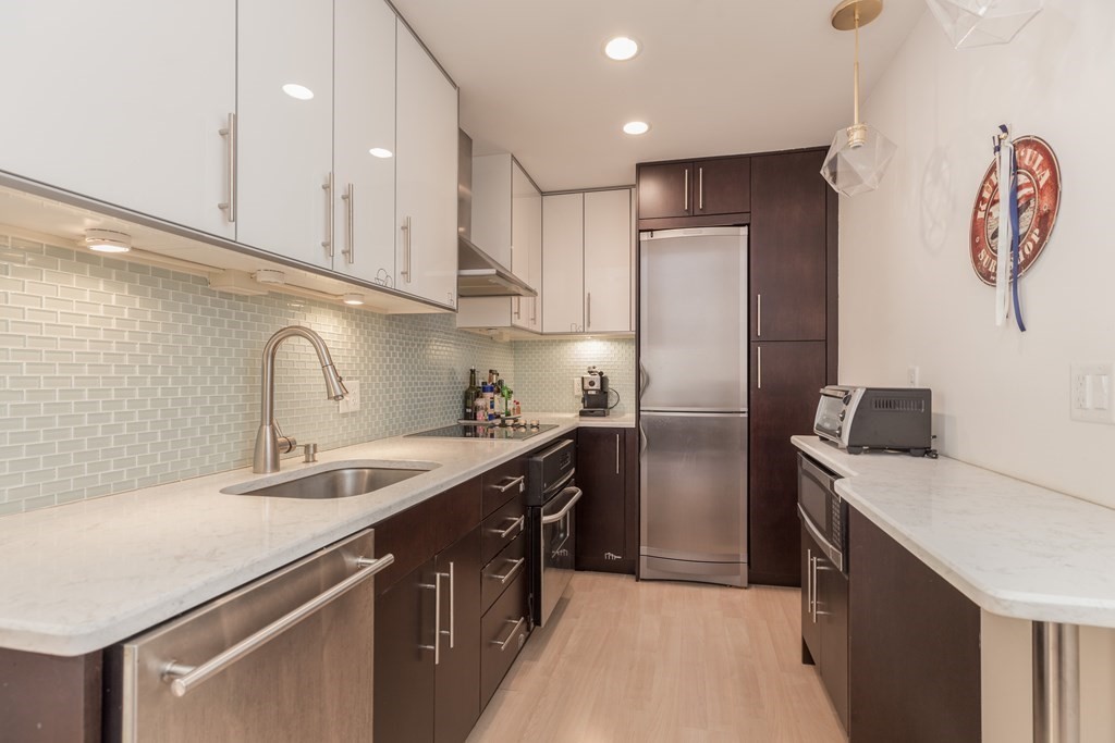 4 Charlesgate East, Unit 107 Boston, MA 02215 - Photo 7 of 12 a kitchen with stainless steel appliances cabinets a sink and a stove