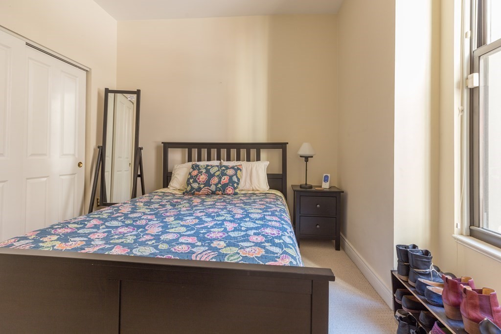 4 Charlesgate East, Unit 107 Boston, MA 02215 - Photo 10 of 12 a bedroom with a bed and a window