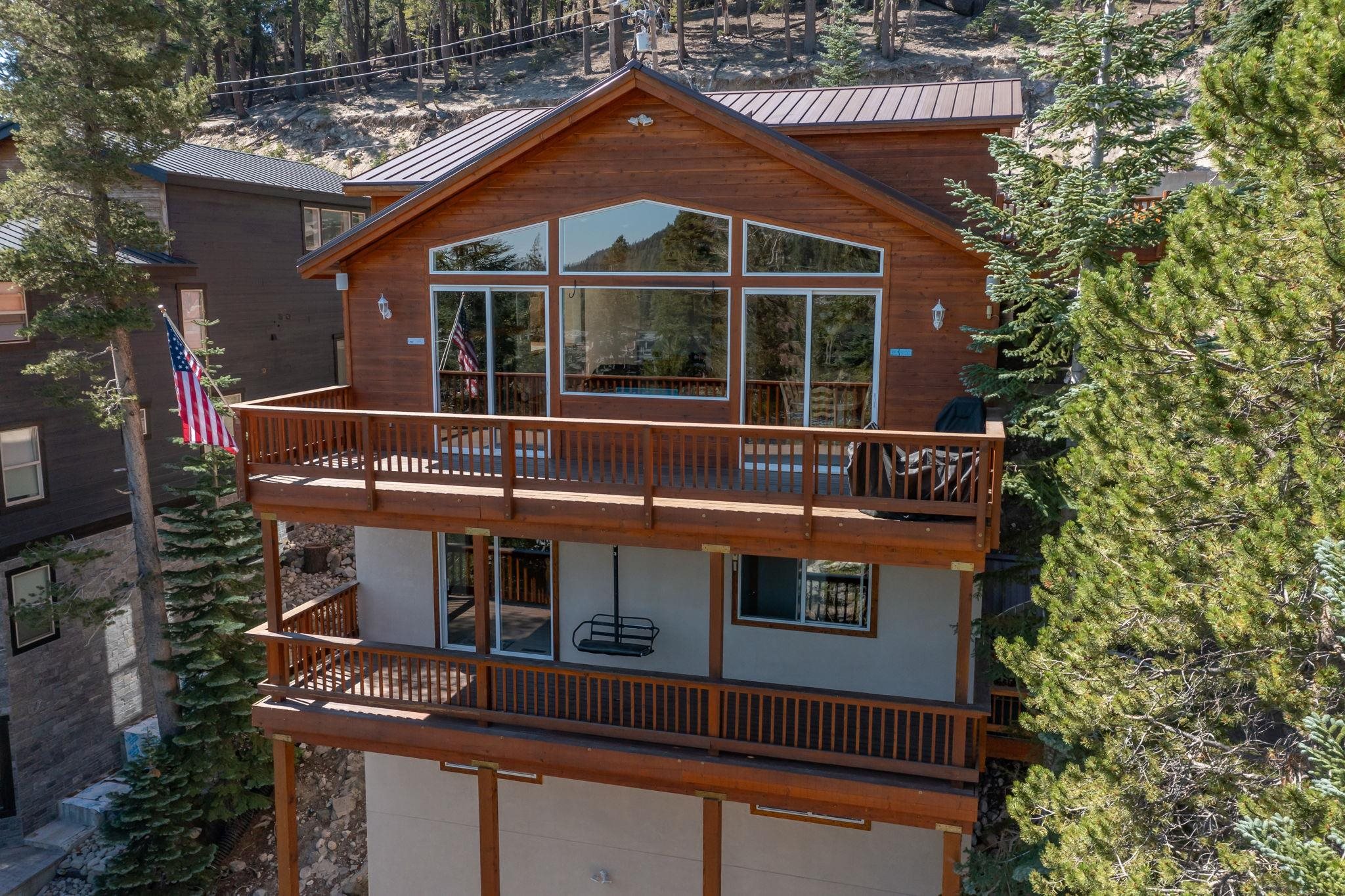 492 John Muir Road Mammoth Lakes, CA 93546 - Photo 30 of 33 Wood-sided exterior featuring multiple decks, extensive fenestration, and a metal roof