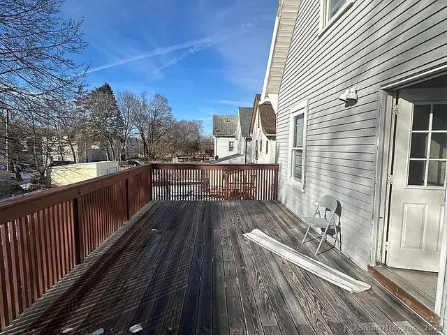 a view of balcony with wooden floor and fence