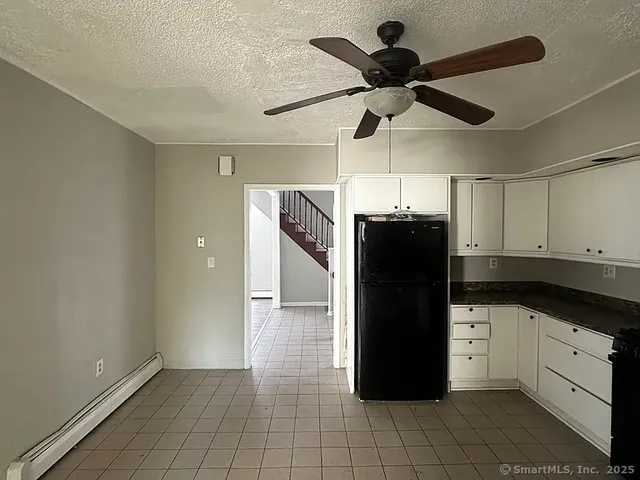 a view of a refrigerator and cabinets