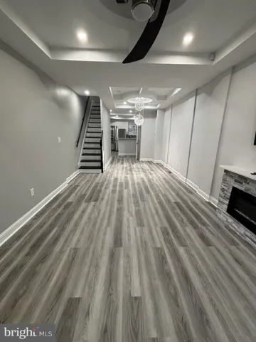 a view of a room with stairs and a wooden floor