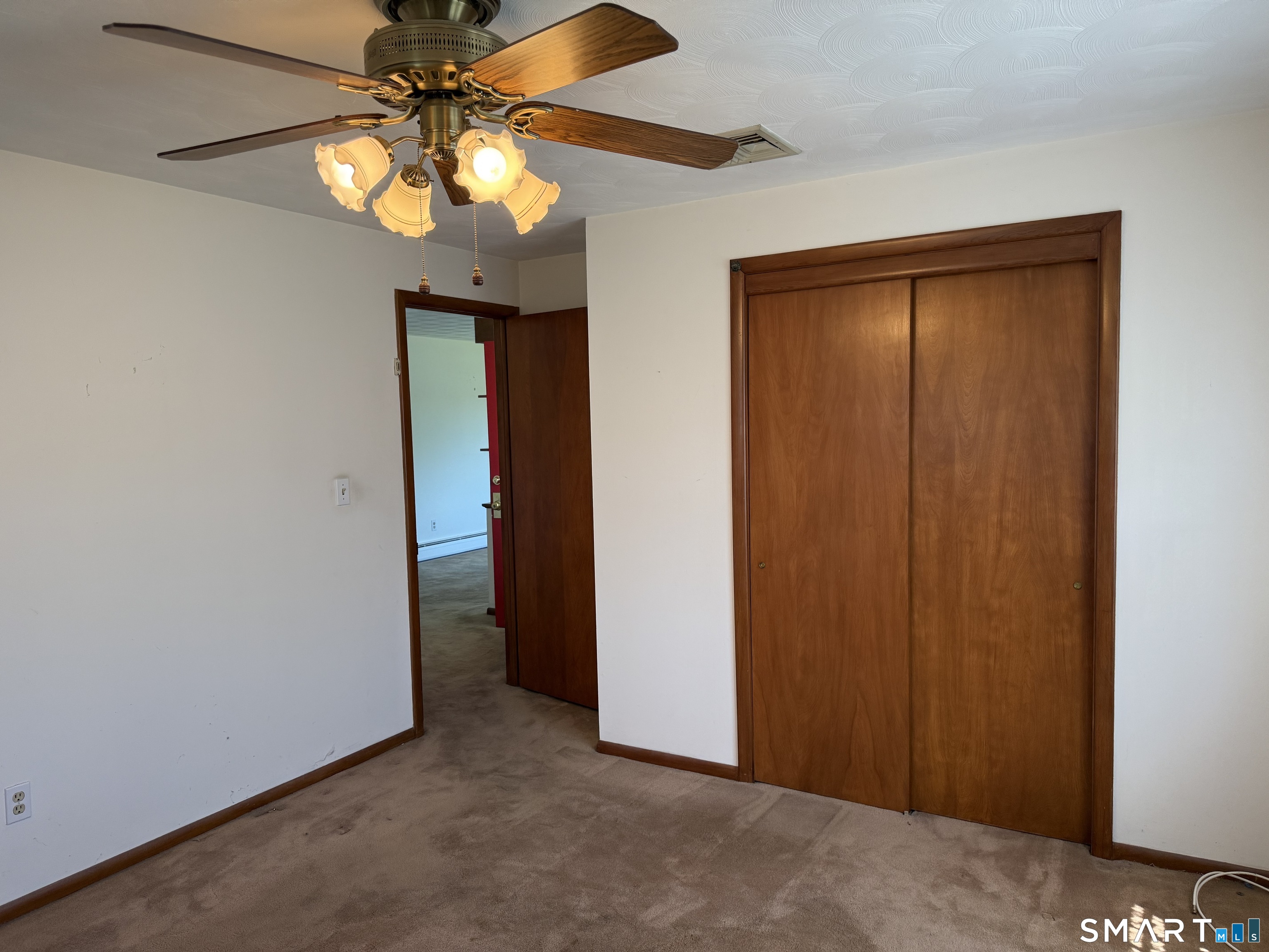 26 Maple Street Trumbull, CT 06611 - Photo 30 of 37 an empty room with a chandelier fan and closet