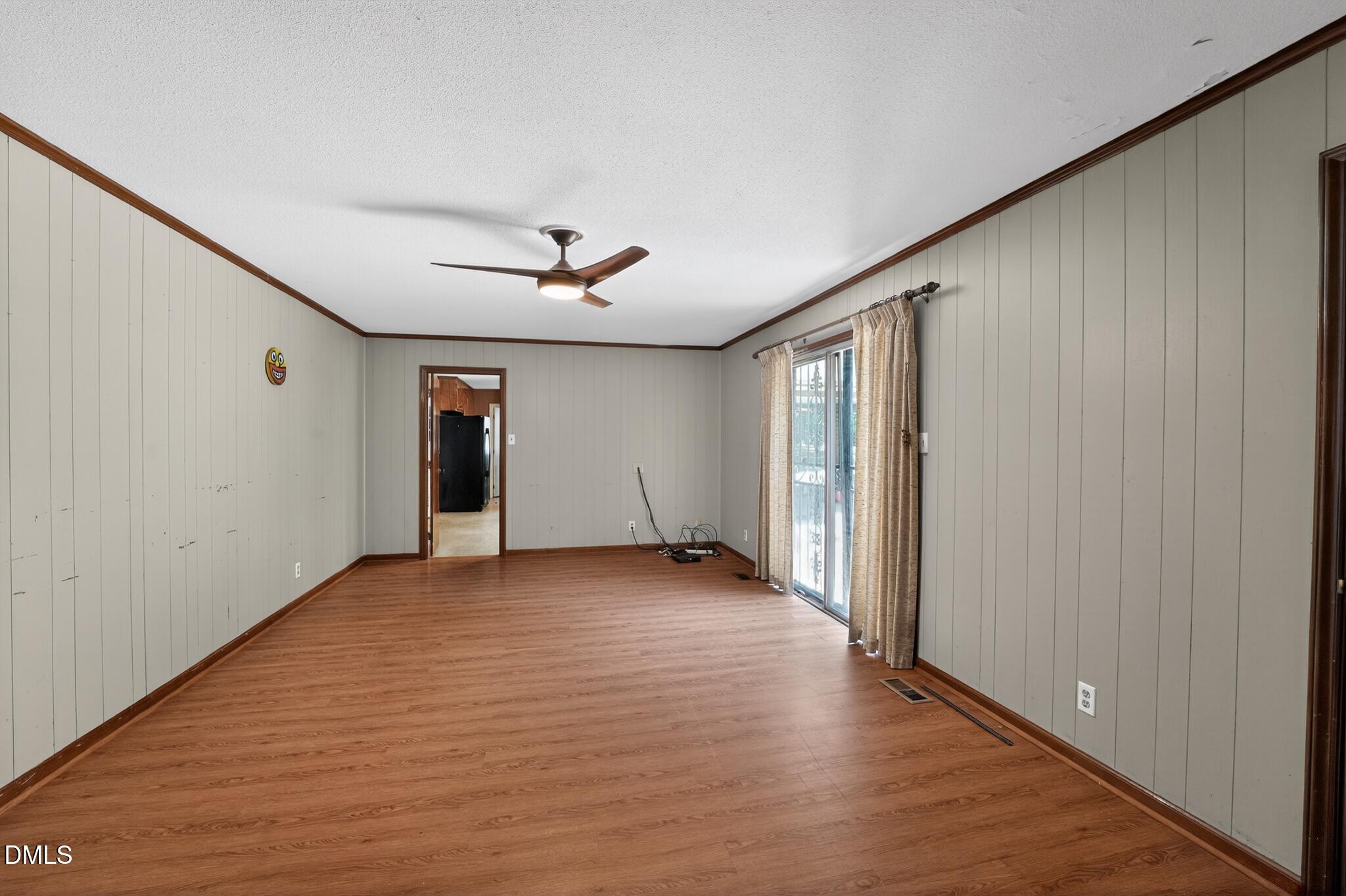 1034 Jerome Road Durham, NC 27713 - Photo 8 of 35 a view of an empty room with window and wooden floor