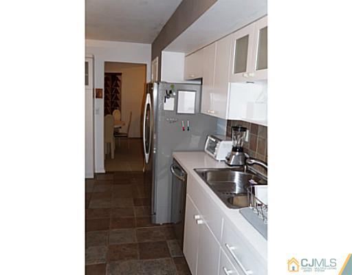 804 New Dover Road Edison, NJ 08820 - Photo 3 of 20 a kitchen with a sink and cabinets