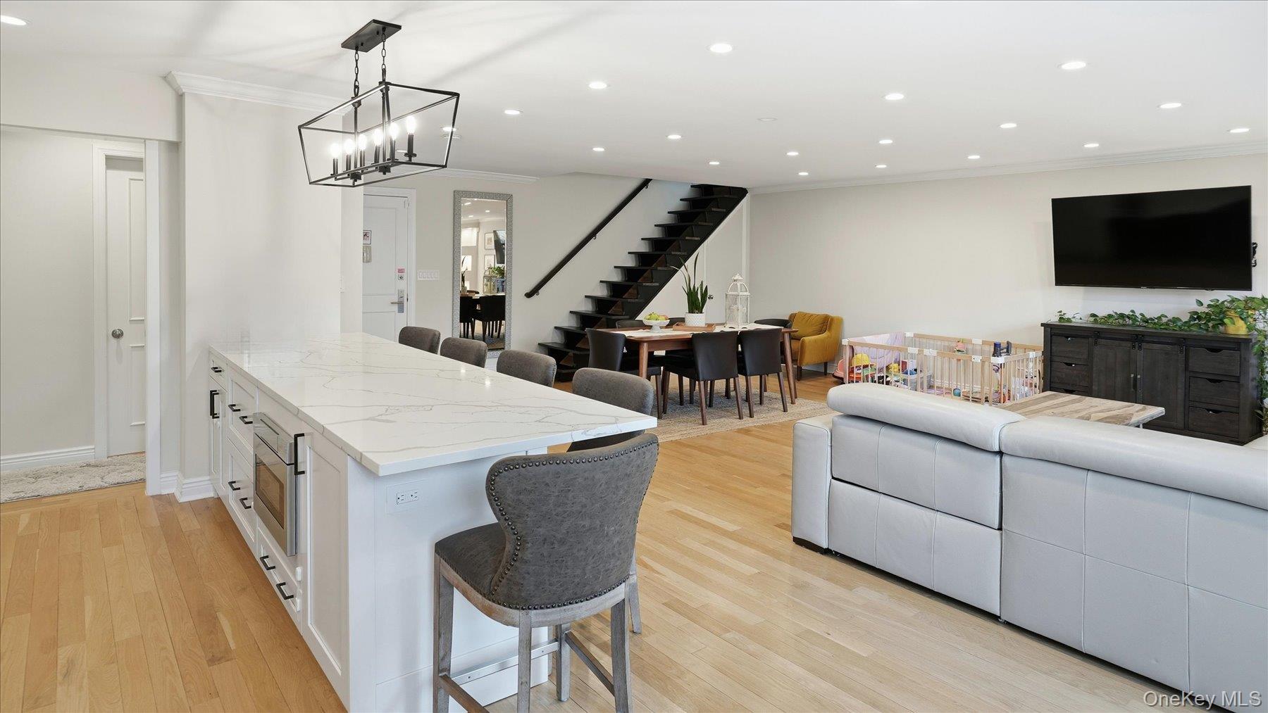 22 Park Place, Unit 4T Great Neck, NY 11021 - Photo 3 of 13 a living room with furniture and a flat screen tv