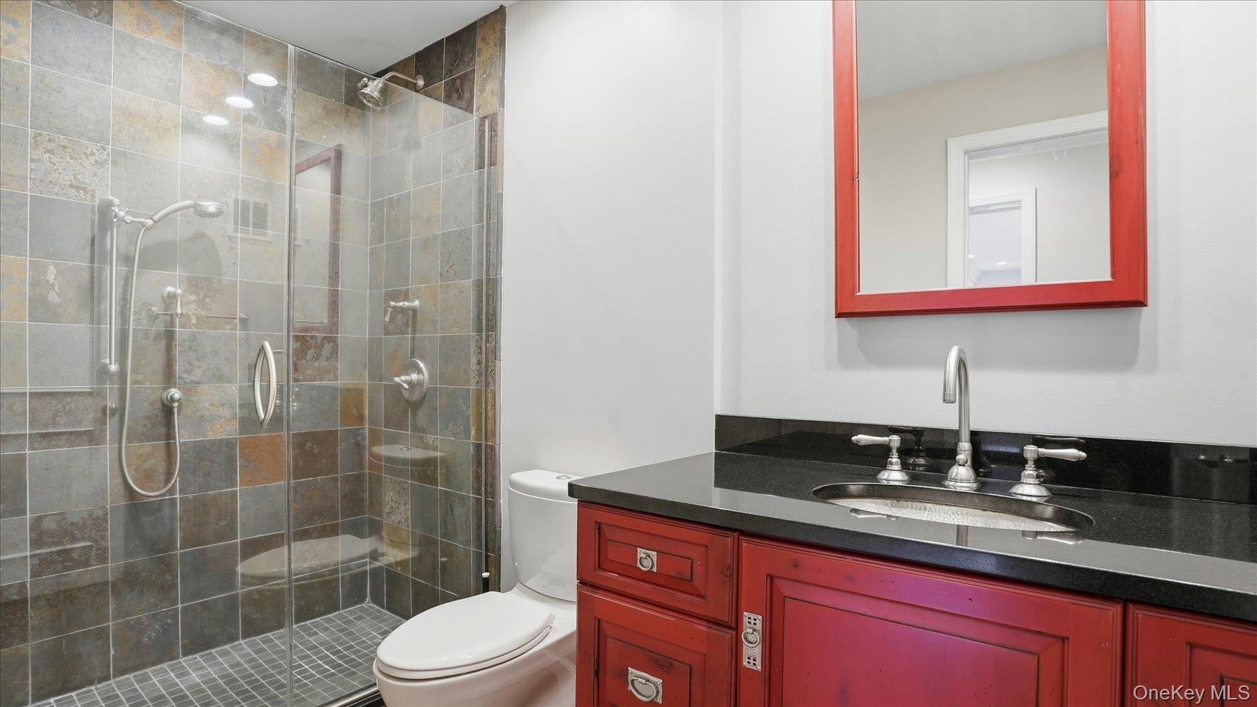 22 Park Place, Unit 4T Great Neck, NY 11021 - Photo 6 of 13 a bathroom with a sink a toilet and shower