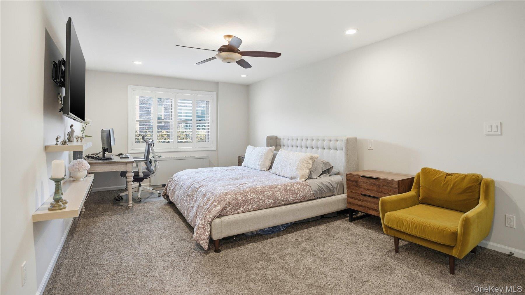 22 Park Place, Unit 4T Great Neck, NY 11021 - Photo 7 of 13 a spacious bedroom with a bed and a couch