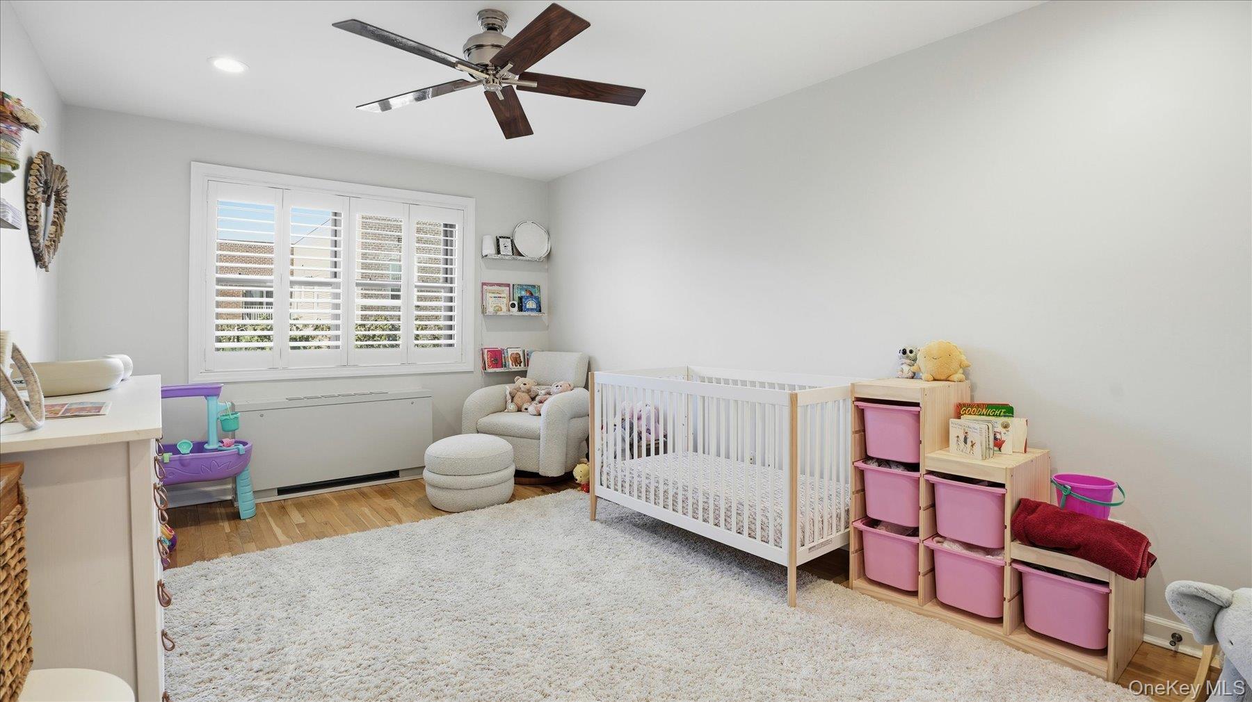 22 Park Place, Unit 4T Great Neck, NY 11021 - Photo 8 of 13 a bedroom with furniture and a window