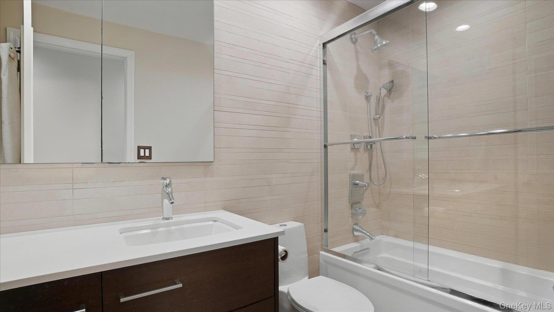 22 Park Place, Unit 4T Great Neck, NY 11021 - Photo 9 of 13 a bathroom with a sink toilet and shower