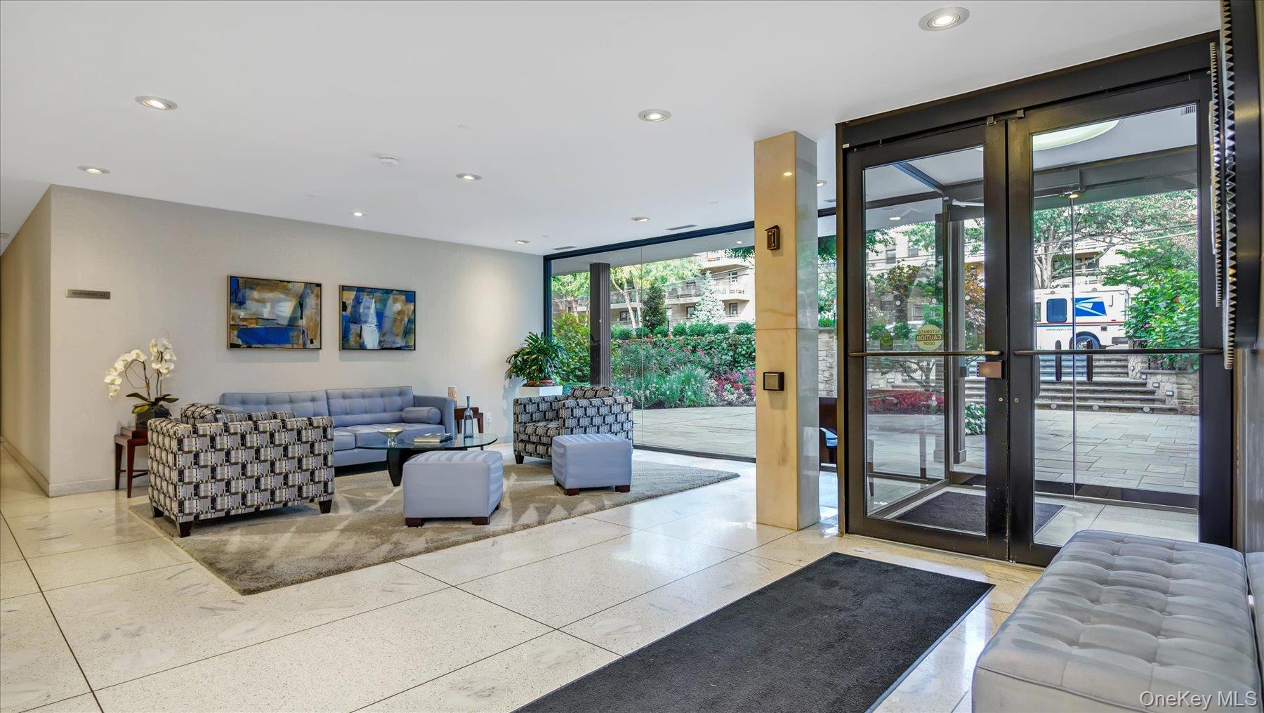 22 Park Place, Unit 4T Great Neck, NY 11021 - Photo 10 of 13 a living room with furniture and large windows