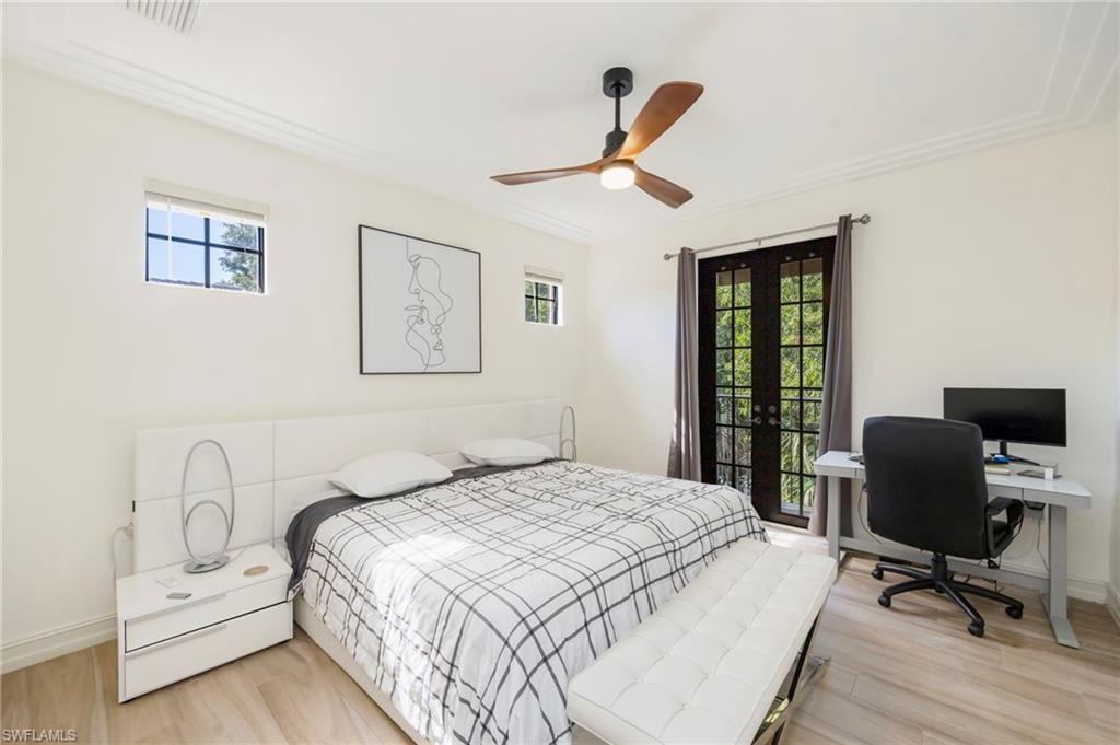 9145 Chula Vista Street, Unit 13004 Naples, FL 34113 - Photo 11 of 24 a bedroom with a bed and a desk