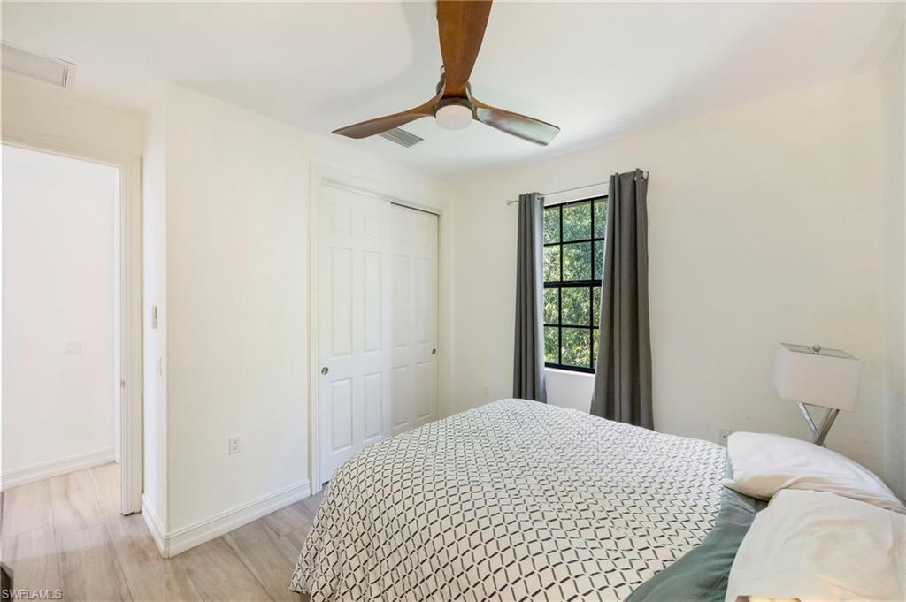 9145 Chula Vista Street, Unit 13004 Naples, FL 34113 - Photo 13 of 24 a bedroom with a bed and a window