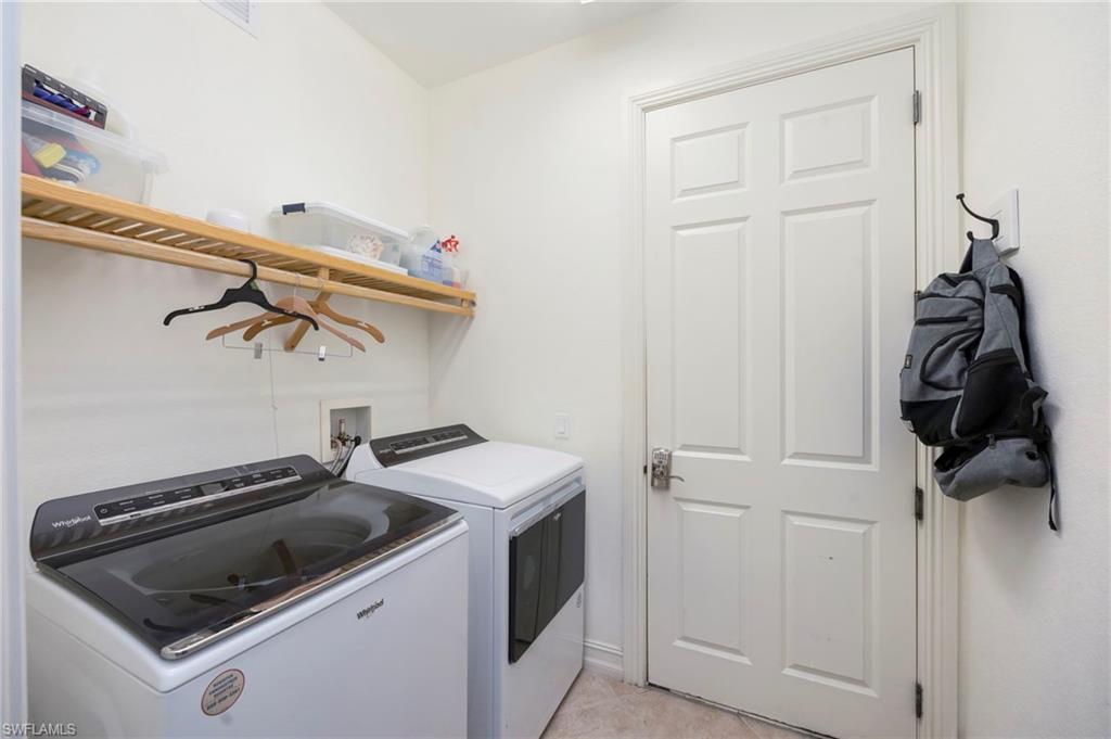 9145 Chula Vista Street, Unit 13004 Naples, FL 34113 - Photo 21 of 24 a utility room with dryer and washer