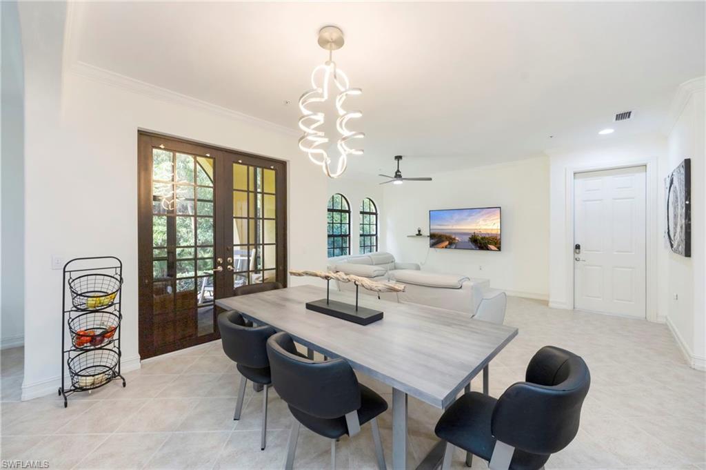 9145 Chula Vista Street, Unit 13004 Naples, FL 34113 - Photo 3 of 24 a dining room with furniture and window