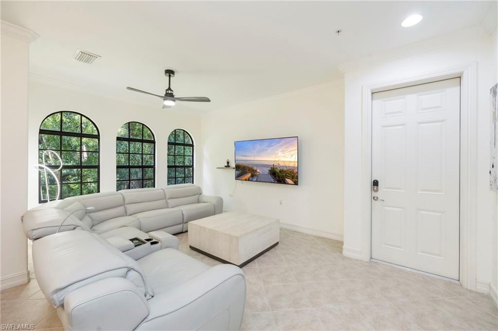 9145 Chula Vista Street, Unit 13004 Naples, FL 34113 - Photo 4 of 24 a living room with furniture and a large window