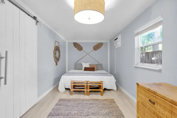 a bedroom with a bed and a window