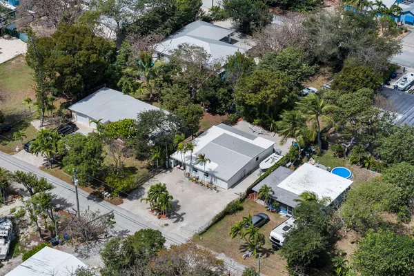an aerial view of a house with outdoor space and a street view