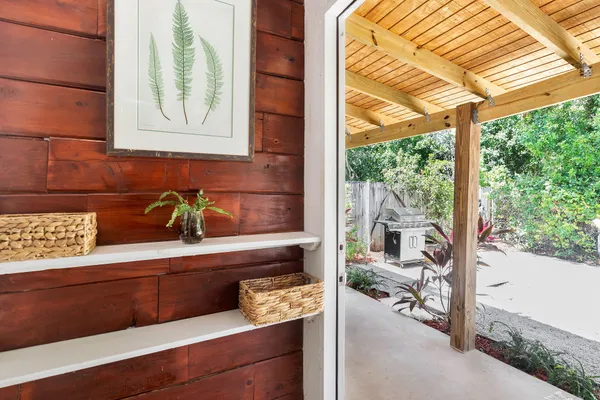 a view of a backyard with plants and a bench