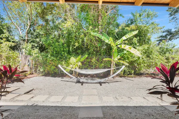 a view of a patio with table and chairs and potted plants