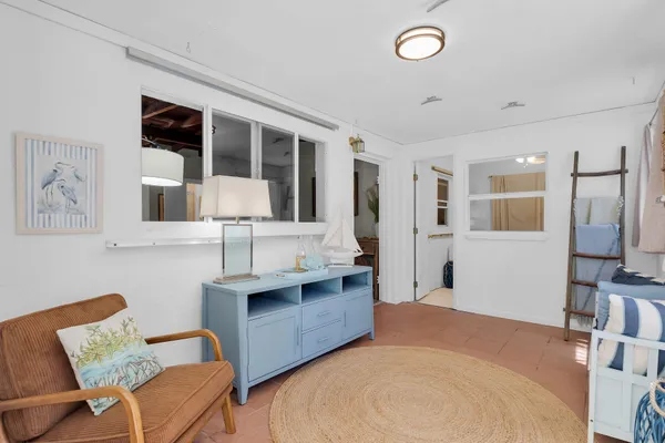 a bedroom with furniture and a flat screen tv