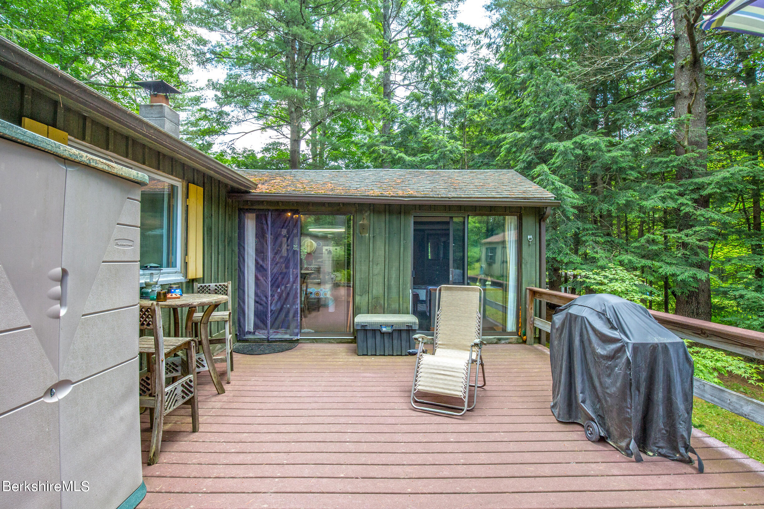1146 East Otis Road Otis, MA 01029 - Photo 17 of 20 a view of a patio with table and chairs potted plants with wooden floor and fence
