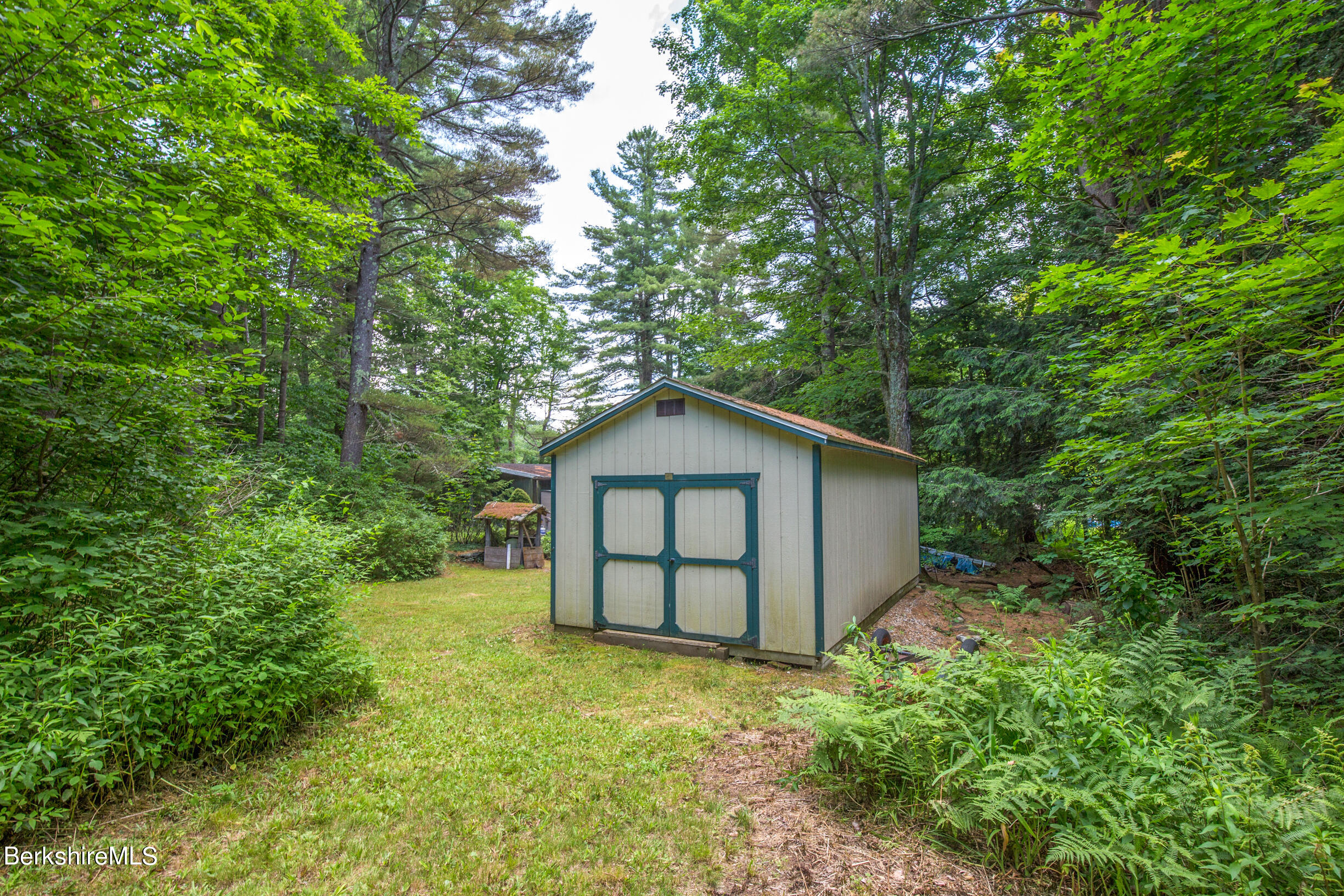 1146 East Otis Road Otis, MA 01029 - Photo 18 of 20 a view of a wooden house with a yard and large trees