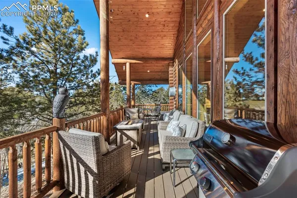 a view of balcony with wooden floor and outdoor seating