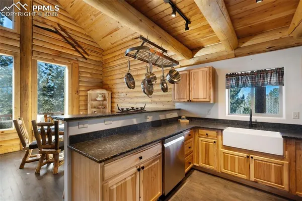 a kitchen with stainless steel appliances granite countertop a refrigerator and a stove