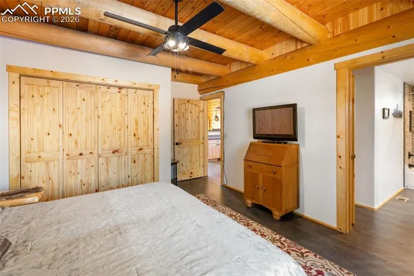 a bedroom with a large bed and a chandelier