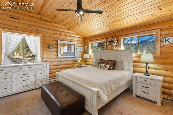 a bedroom with a bed a flat screen tv and dresser