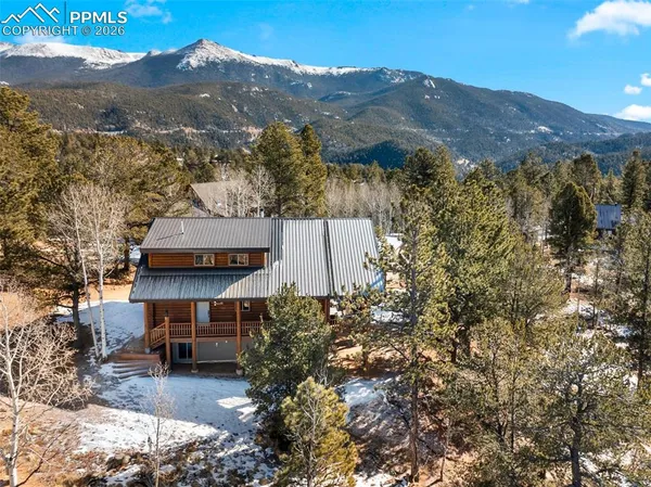an aerial view of a house with a mountain view