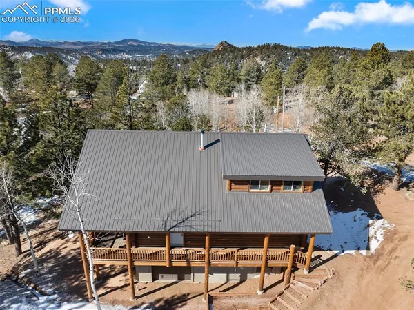an aerial view of a house with a yard and sitting space
