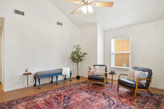 a living room with furniture and a potted plant