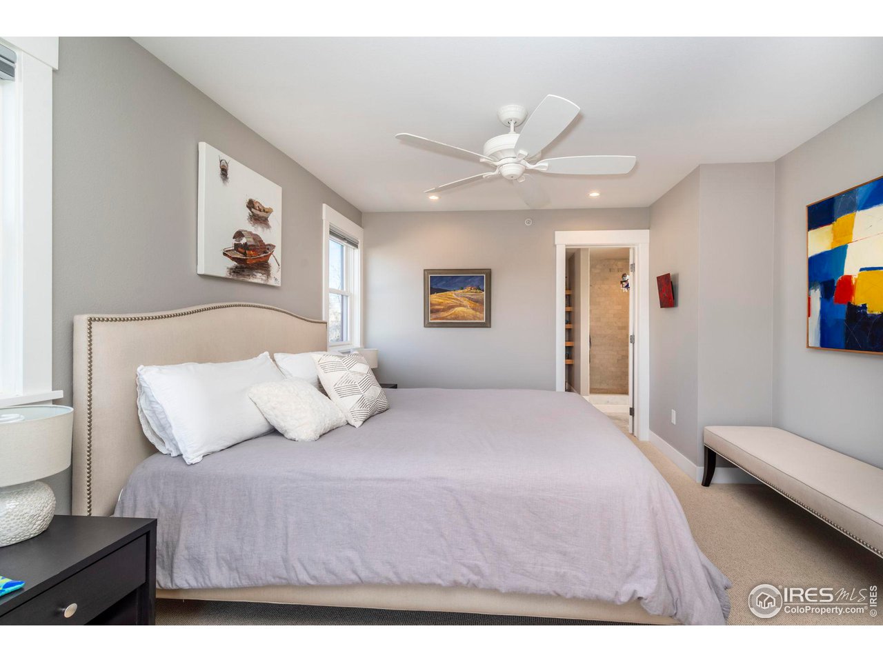 2058 Walnut Street, Unit A Boulder, CO 80302 - Photo 19 of 38 a bedroom with a large bed and a chandelier