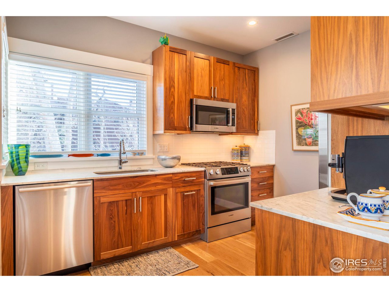 2058 Walnut Street, Unit A Boulder, CO 80302 - Photo 3 of 38 a kitchen with stainless steel appliances granite countertop a stove a sink dishwasher and a microwave oven with cabinets