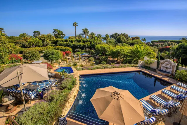 a view of an house with backyard space and balcony