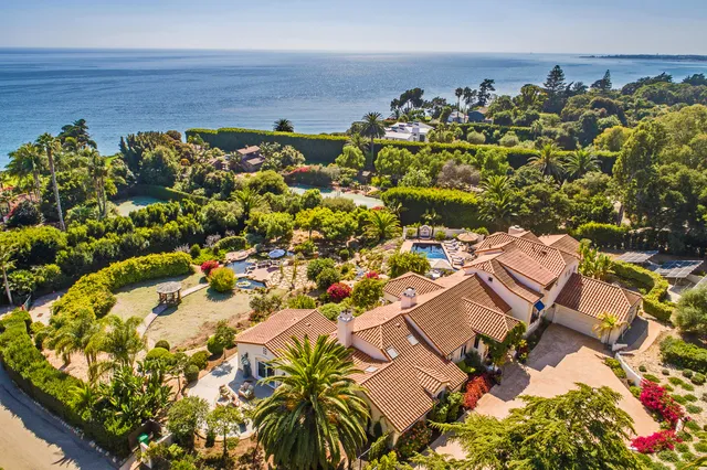 a view of an outdoor sitting area with furniture and umbrella