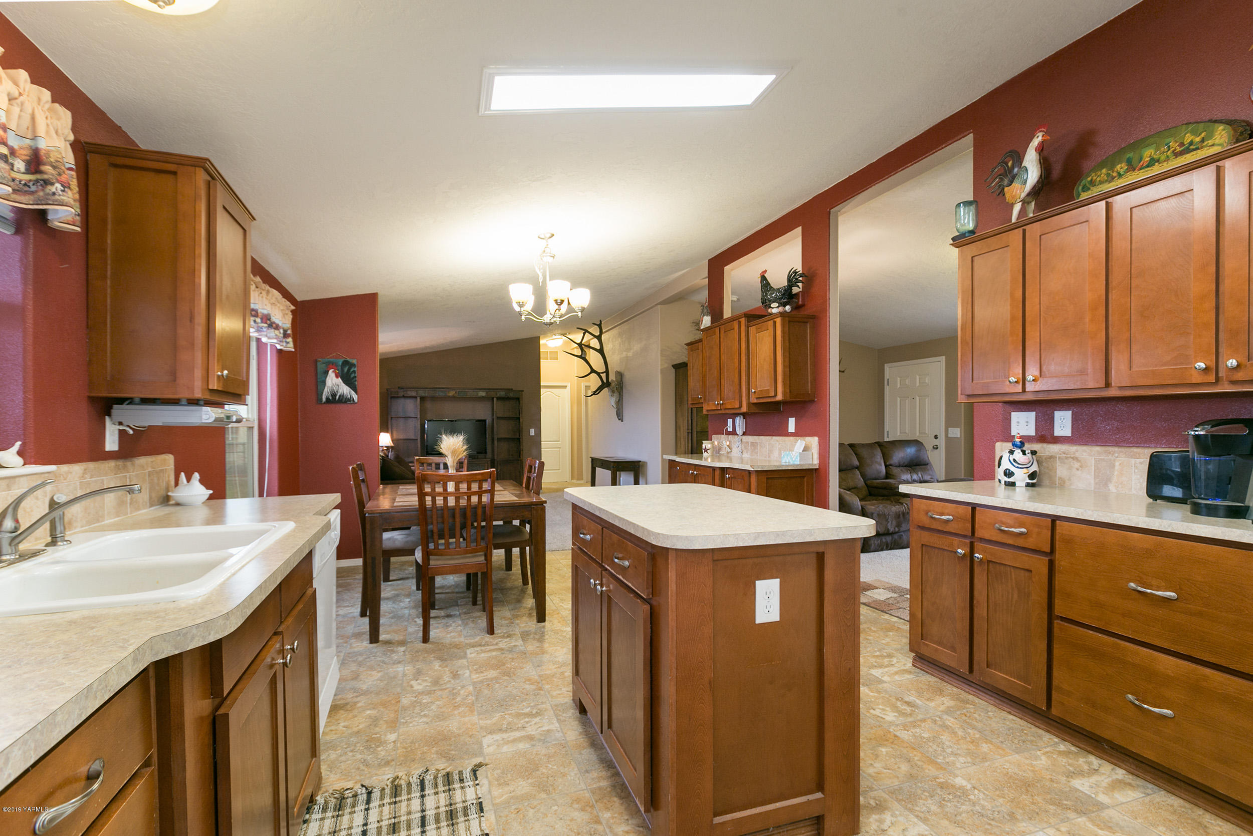 177 Division Road Zillah, WA 98953 - Photo 12 of 23 a kitchen with a sink a stove and chairs