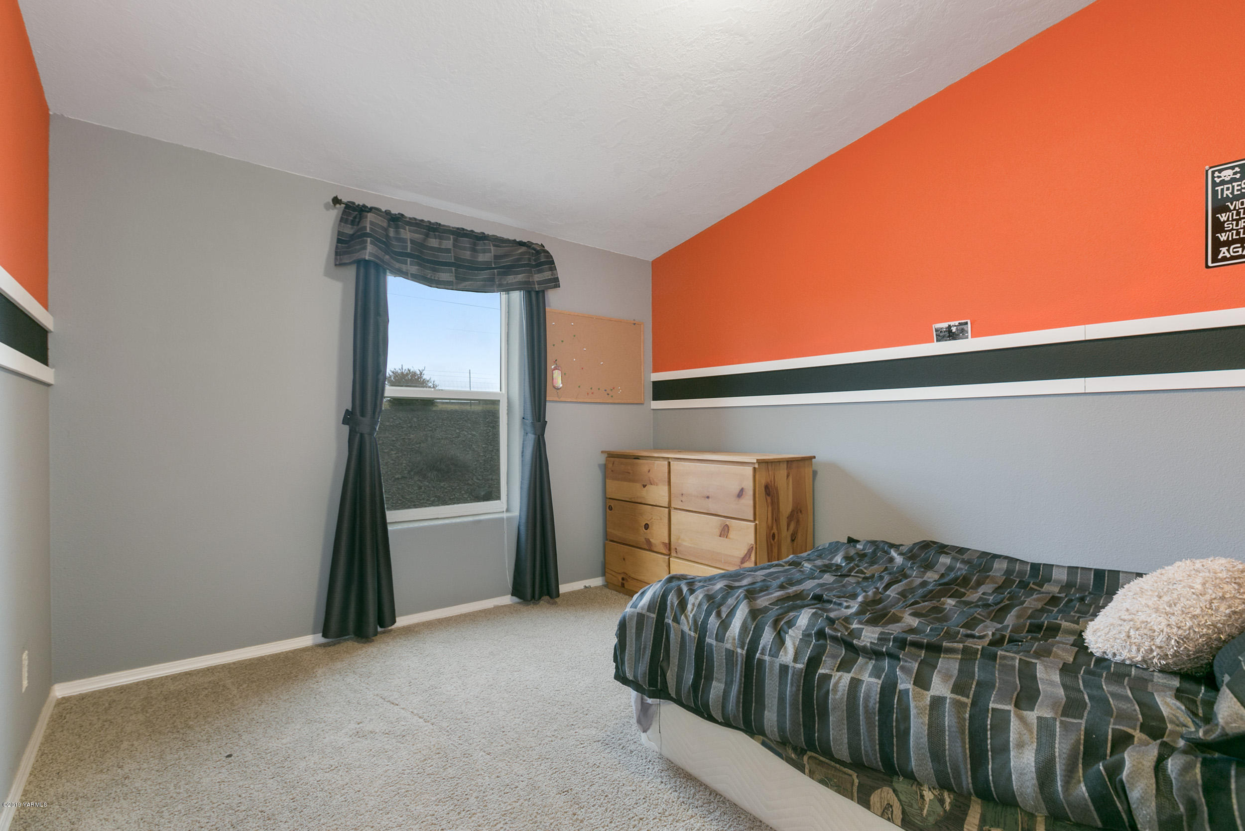177 Division Road Zillah, WA 98953 - Photo 16 of 23 a bedroom with a bed and dresser