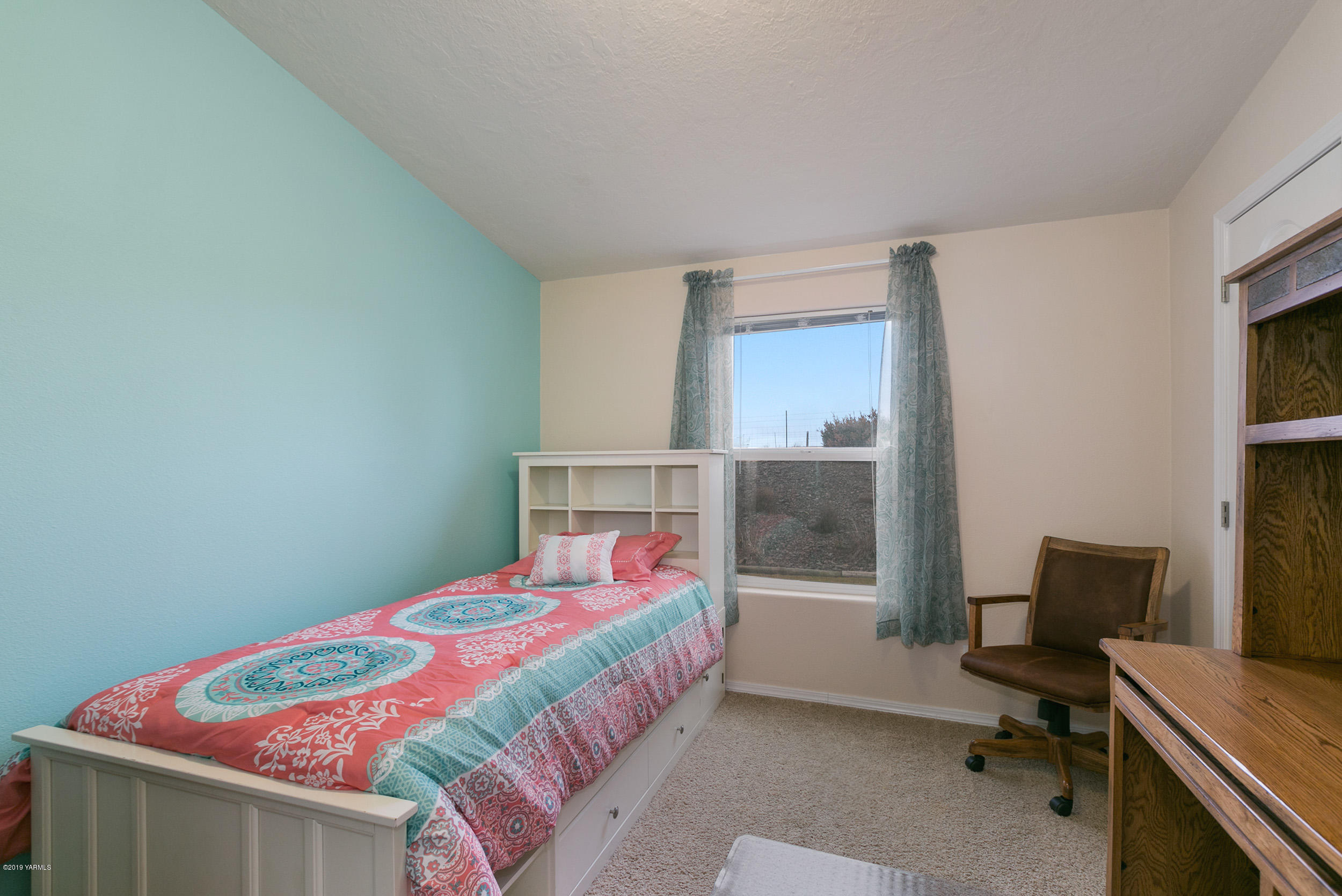 177 Division Road Zillah, WA 98953 - Photo 17 of 23 a bedroom with a bed and a desk