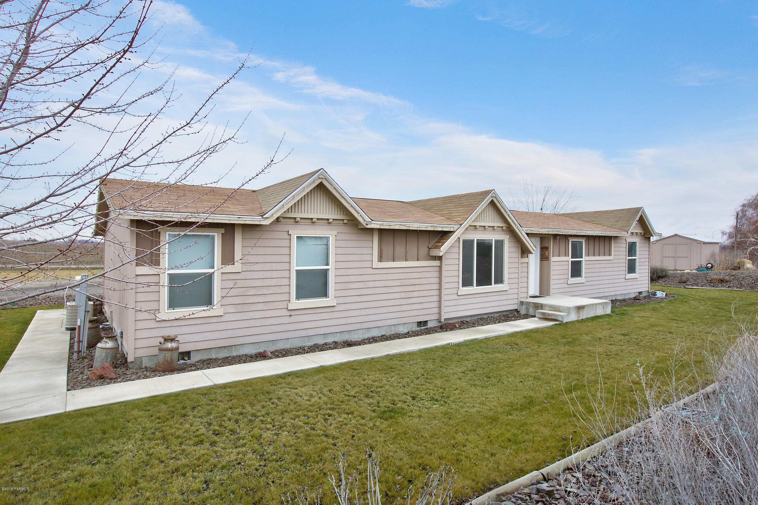 177 Division Road Zillah, WA 98953 - Photo 3 of 23 a front view of a house with a yard