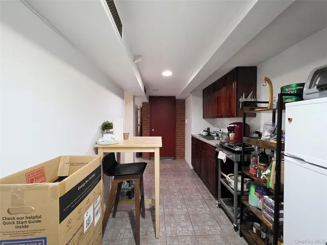 a kitchen with stainless steel appliances kitchen island granite countertop a table chairs in it and wooden floors