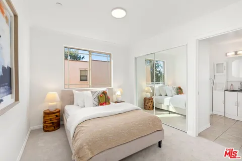 a bedroom with a bed and a couch