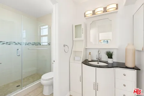 a bathroom with a toilet a sink and shower