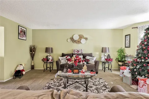 a living room with furniture and flowers
