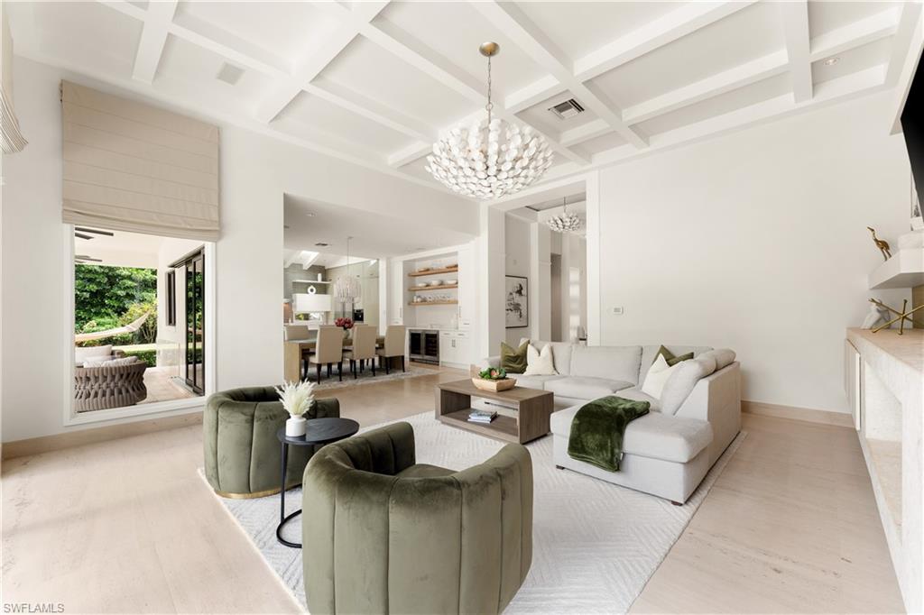 233 Ridge Drive Naples, FL 34108 - Photo 12 of 39 a living room with furniture and a chandelier