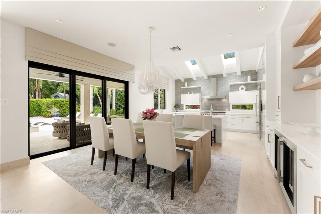233 Ridge Drive Naples, FL 34108 - Photo 14 of 39 a dining room with furniture and a floor to ceiling window