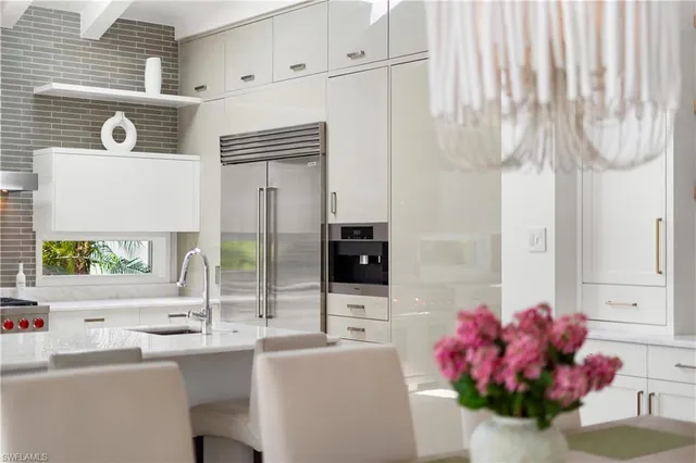 a kitchen with a sink dishwasher a refrigerator and a stove